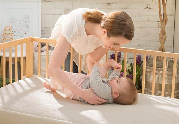 satara-home-naturepedic-organic-breathable-ultra-2-stage-chemical-free-crib-mattress-mom-with-baby-lifestyle-image